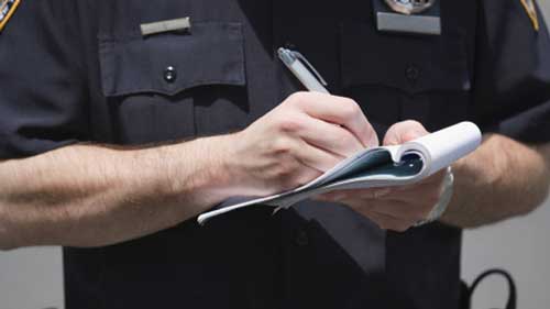 Officer writing ticket